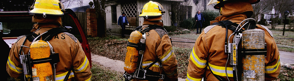 four fire fighters facing property