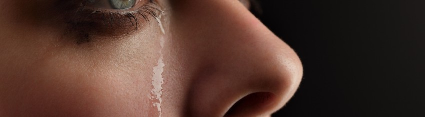 closeup of young woman with teared stained face